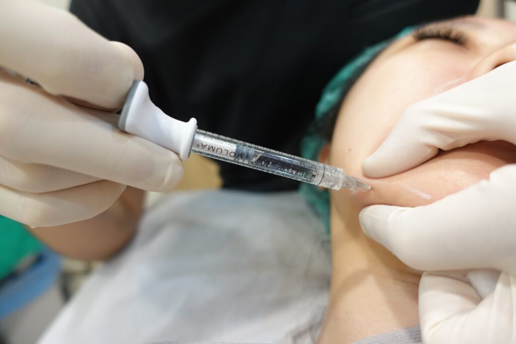 Close-up of a doctor injecting Juvederm Voluma along the jawline